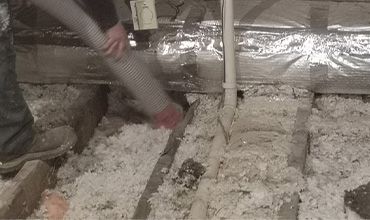 Worker removing insulation